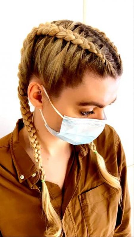 Girl with two cornrow plaits at the klinik salon 