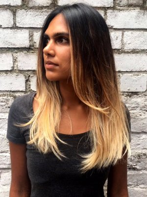 Dark brown hair balayaged into a light blonde and blowdried in to a textured beachy finish by Thea at the klinik salon Farringdon London