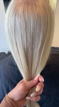 hand holding a natural white hair beng coloured at the klinik hairdressing London