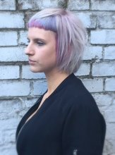 Hair has been cut into a mullet bob with a micro fringe coloured into a subtle lavender in the fringe area at the klinik salon done by Mark