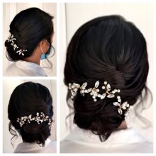 Dark hair done up in a loose tousled bun with hair jewellery at the back by Corina at the klink salon
