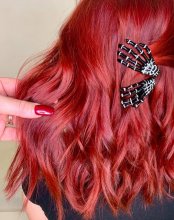 bright red hair with two halloween hand as hair clips at the klinik salon London