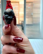 a hand holding a tiny santa revealing its only 12 weeks until Christmas at the klinik salon